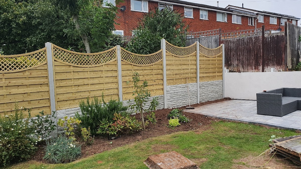 Decorative wave-top lattice fence panels on concrete gravel boards, finished beside a patio