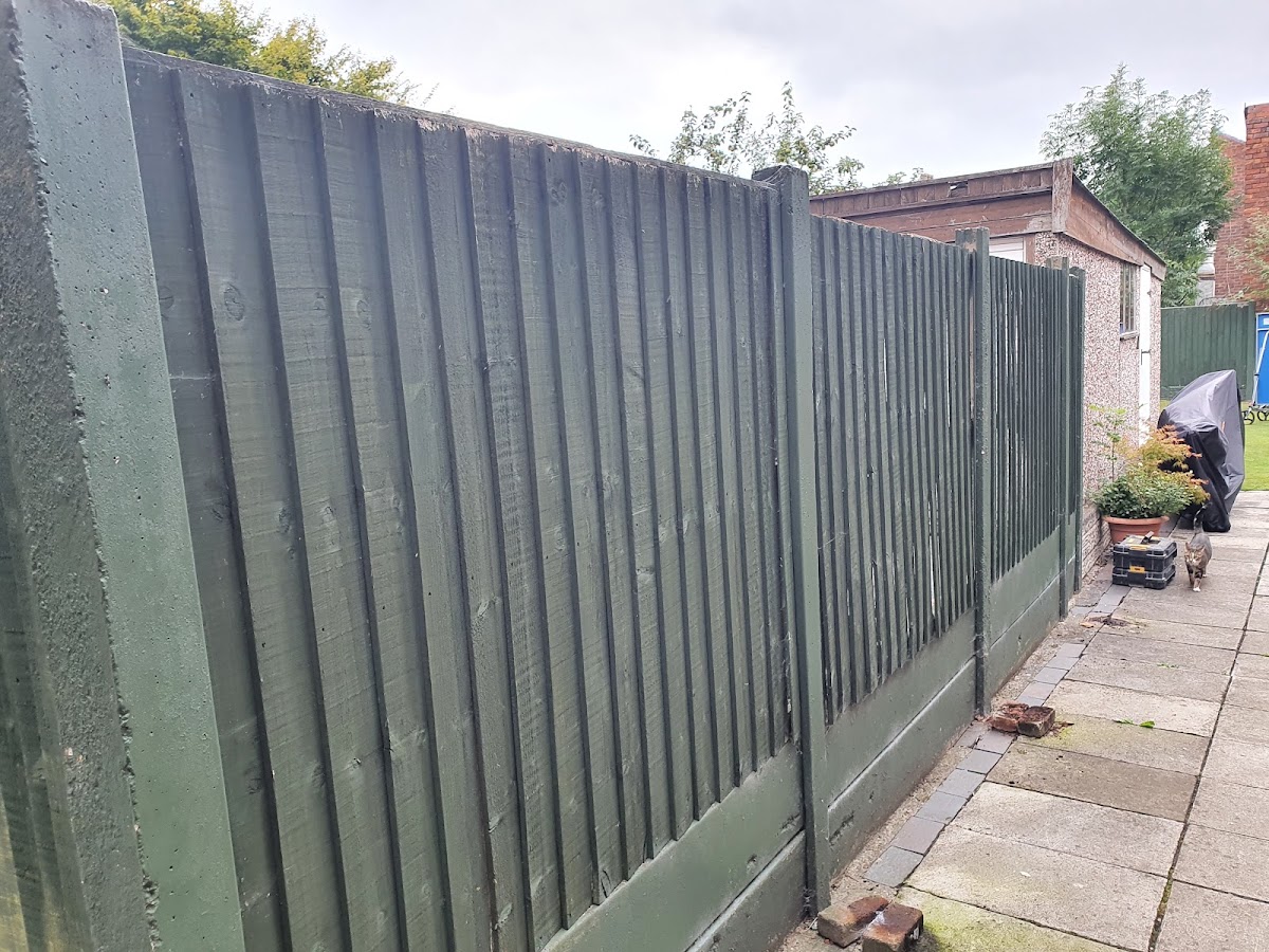 Green-treated closeboard fence on concrete posts and gravel boards